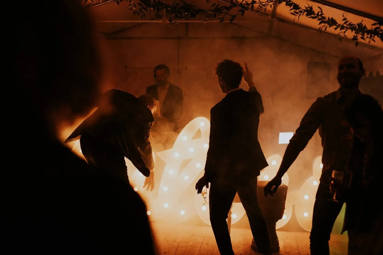 Silhouettes dancing in front of a glowing fire