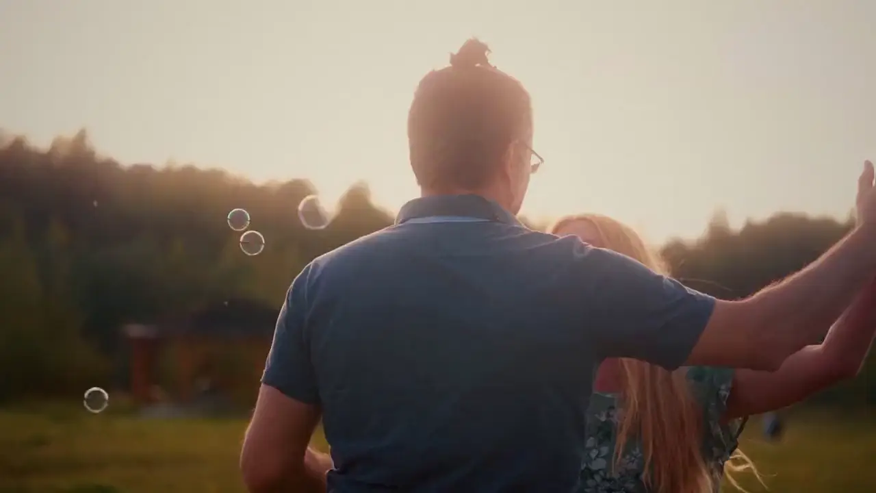 A bouquet held by a couple at golden hour